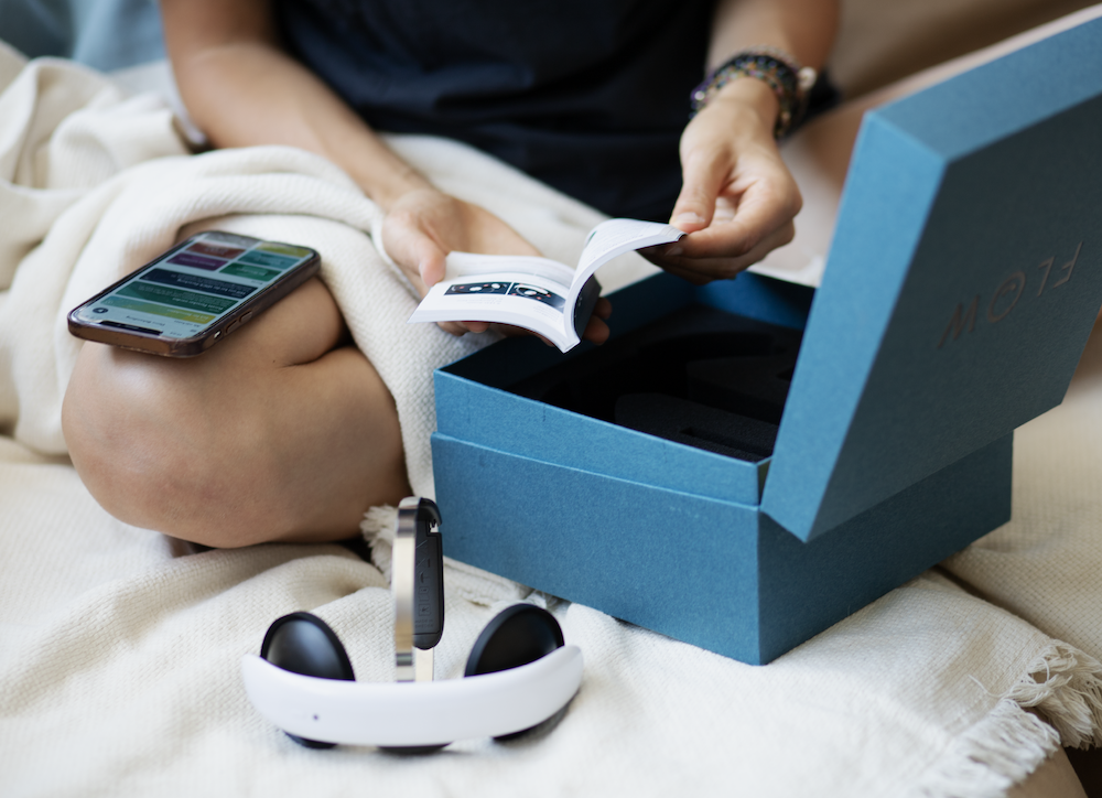 Person setting up Flow tDCS device